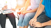 Chlamydien: Ein Mann und eine Frau sitzen neben einem Arzt, der ein erstes Patientengespr&auml;ch mit ihnen f&uuml;hrt.